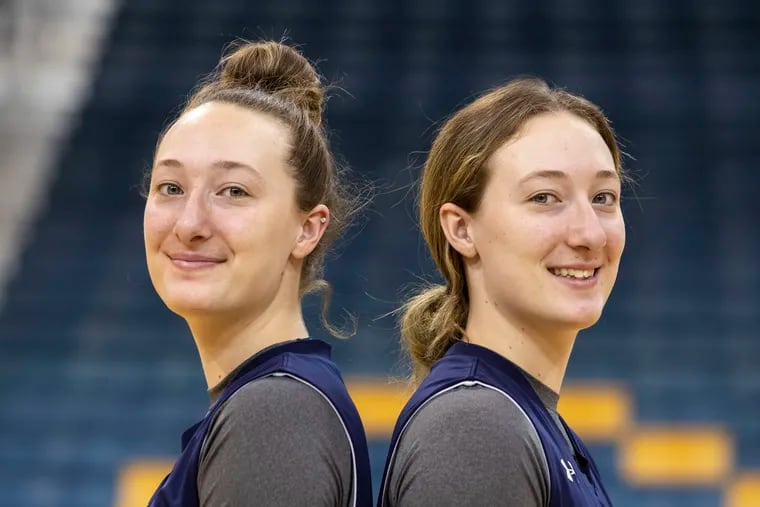 Identical twins from Australia, (left to right) Amy Jacobs (24) and Claire Jacobs (10) pose for a portrait after practice in the Tom Gola Arena at the TruMark Financial Center at La Salle University in Philadelphia, Pennsylvania, on Thursday, January 9, 2020.