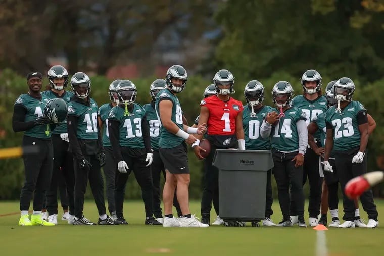 The Eagles offense including Philadelphia Eagles quarterback Jalen Hurts (Center) listen to instructions for a drill during practice at the NovaCare Complex in South Philadelphia on Thursday, Sept. 28, 2023. The Eagles will host the Washington Commanders on Sunday.