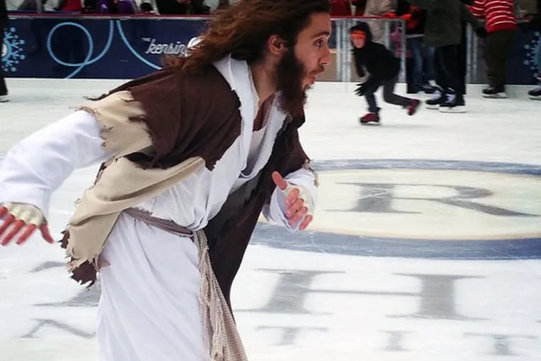 Michael Grant, 28, aka "Philly Jesus," takes a few laps around the new Dilworth Plaza skating rink.