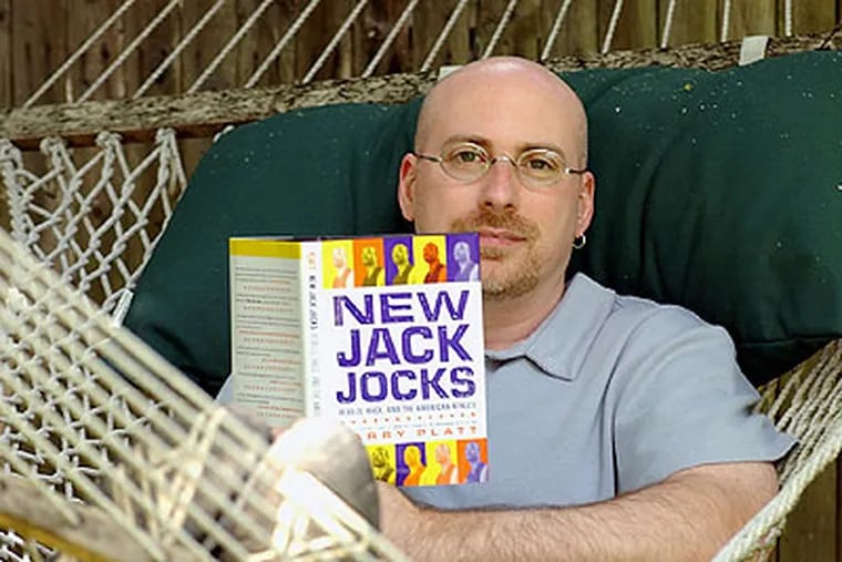 Larry Platt lays in a hammock in the backyard of his Ardmore home with his own book in 2002. (Bonnie Weller / Staff Photographer)