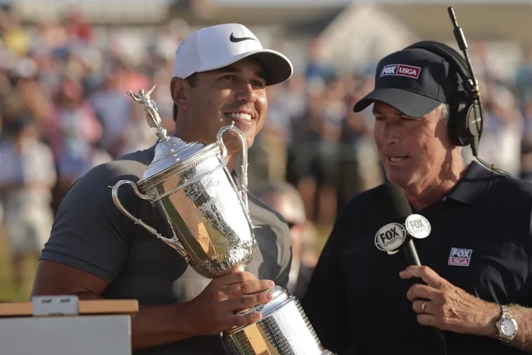 Brooks Koepka is interviewed by Curtis Strange after winning the U.S. Open Sunday in Southampton, N.Y.
