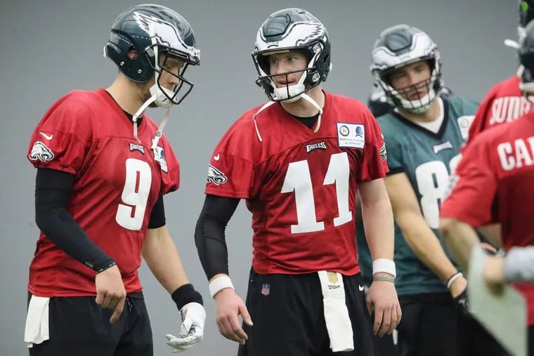 Eagles quarterbacks Carson Wentz (right) and Nick Foles talk during practice at the NovaCare Complex in South Philadelphia on Tuesday, May 22, 2018. Tuesday was the first day of the Eagles’ organized team activities.