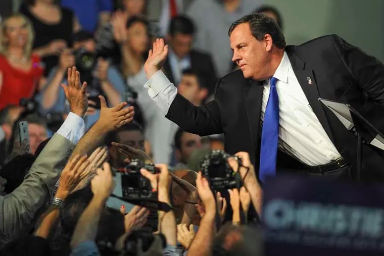 New Jersey Gov. Chris Christie slaps high-fives with supporters in the Livingston High School gym after announcing his candidacy for the GOP nomination for President in 2015. Christie is an alumnus of the high school.