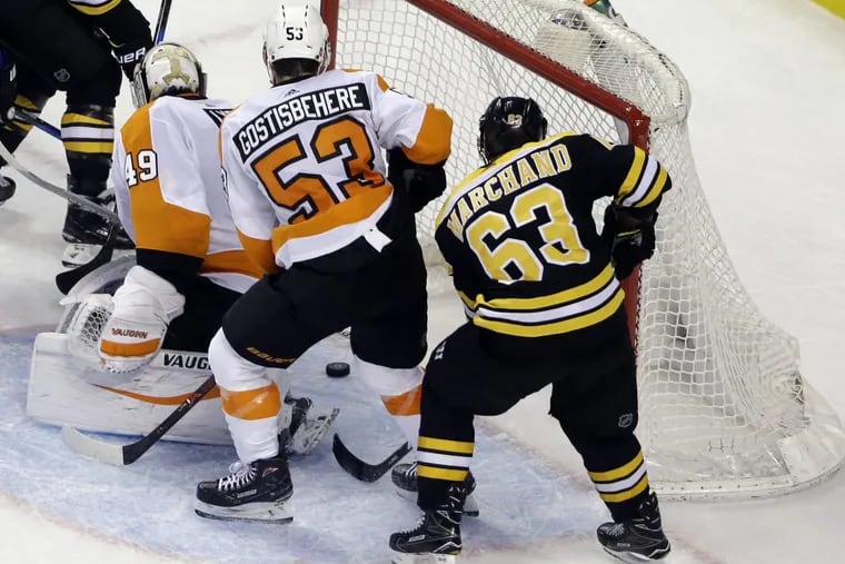Boston Bruins left wing Brad Marchand (63) scores past Flyers goaltender Alex Lyon (49) as Flyers defenseman Shayne Gostisbehere (53) watches with less than a minute to go in the third period of the Flyers’ loss.