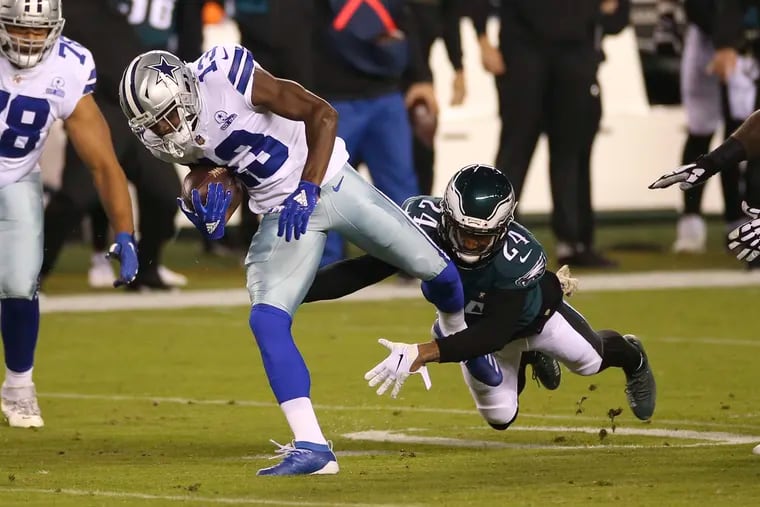 Eagles cornerback Darius Slay tackles Dallas wide receiver Michael Gallup, before Slay left Sunday night's game with an ankle injury that apparently is not serious.