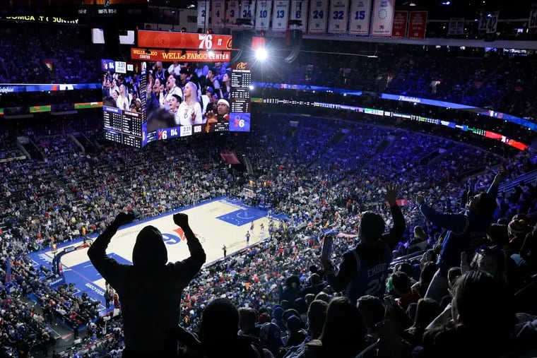 Fans cheer during a timeout at a Cleveland Cavaliers-Philadelphia 76ers at the Wells Fargo Center in March. The Broad Street subway runs to the South Philly sports arenas, but Center City would offer more transit options.