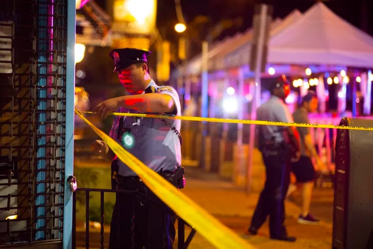 Philadelphia police tape off an area at Third and South Streets near the scene of a mass shooting on South Street late Saturday, June 4, 2022.