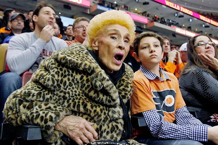 Lina Antonelli cheers on the Flyers with (from left) great-nephew Bruno, niece Laura Antonelli, and her niece's husband, Keith Freeman.