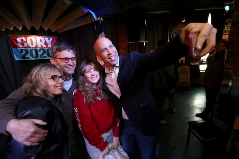 Democratic presidential candidate Sen. Cory Booker (D., N.J.) takes a selfie with (from left) Mary Bichell; her husband, Ken; and daughter, Maddie, 12, during an event at Smokestack in Dubuque, Iowa, on Sunday.