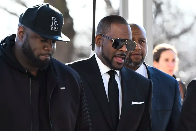 R. Kelly, right, arrives at the Leighton Criminal Court for a hearing on Friday, March 22, 2019, in Chicago.