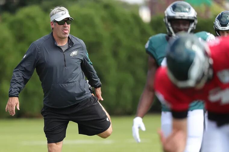 Eagles head coach Doug Pederson tries stretching during Eagles practice at the NovaCare Complex in Philadelphia, PA on October 3, 2018. DAVID MAIALETTI / Staff Photographer
