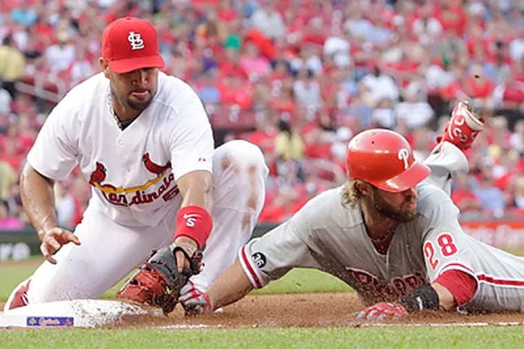 Jayson Werth was caught off first base by a throw from Cardinals' catcher Yadier Molina. (AP Photo/Tom Gannam)