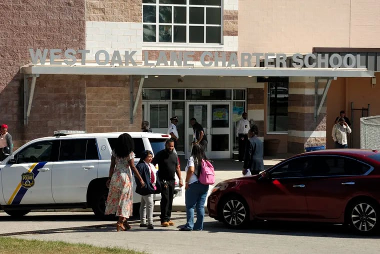 Students are picked up early Friday at West Oak Lane Charter School, where a student passed out pot-laced edibles to other children. Police remain on the scene to investigate. BASTIAAN SLABBERS / For the Inquirer