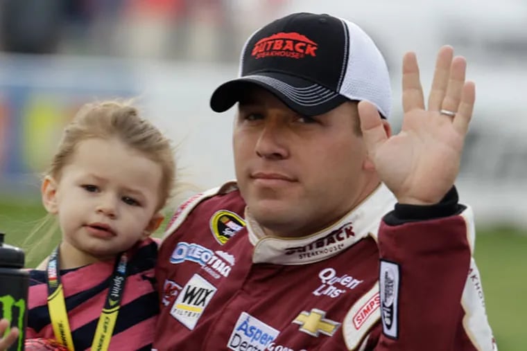 Ryan Newman holds his daughter Brooklyn Sage Newman during driver introductions prior to the start of the Toyota Owner's 400 NASCAR Sprint Cup series auto race at Richmond International Raceway in Richmond, Va., Saturday April 27, 2013. (Steve Helber/AP)