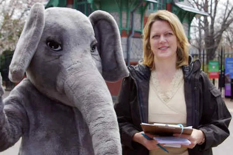 Standing with a costumed mascot, Marianne Bessey - aka Rowan Morrison - alerts zoo-goers to the abuse heaped on elephants in circuses, and questionable treatment in zoos.