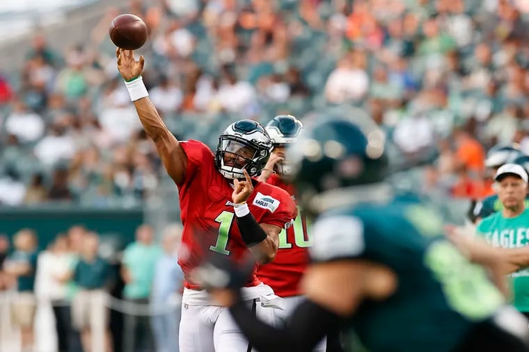 Eagles quarterback Jalen Hurts throws the football to tight end Zach Ertz during training camp at Lincoln Financial Field on Sunday.