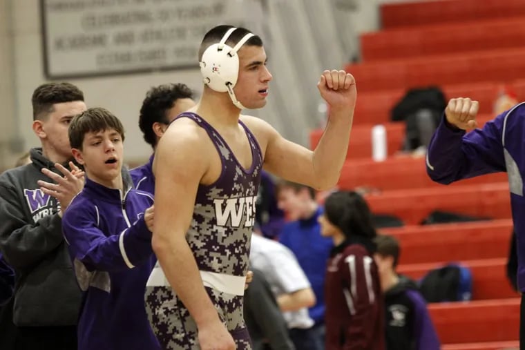 Cherry Hill West’s Max Sullivan walks on the mat for his heavyweight match against Lenape’s Jared Davenport on Wednesday.