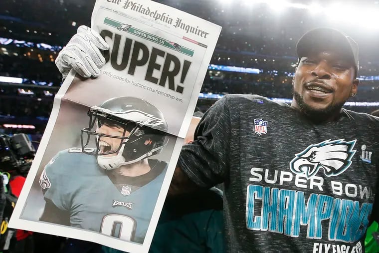 Eagles outside linebacker Nigel Bradham holds the Inquirer after the Eagles beat the New England Patriots in Super Bowl LII.