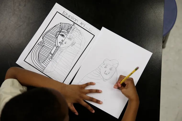 First-grader K'or Goodman, 6, works on a drawing of King Tut's mask during art class at Global Leadership Academy Charter School in West Philadelphia last week. The school emphasizes exposure to international cultures and experiences.