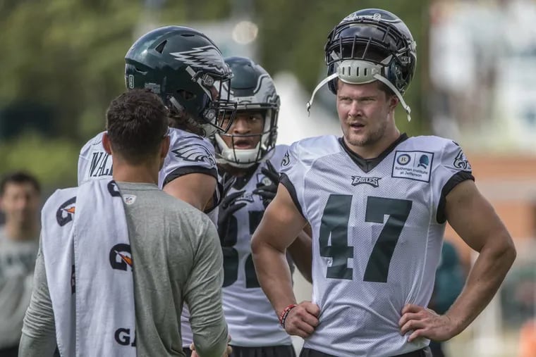 Eagles rookie Nate Gerry (47)   talks with fellow linebackers during a break at training camp on Monday.