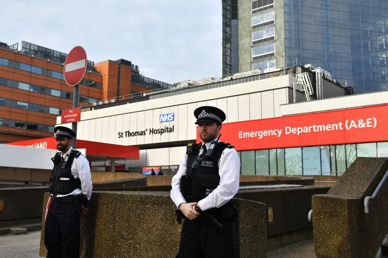Police officers stand outside St Thomas' Hospital in central London, where Prime Minister Boris Johnson remains in intensive care.