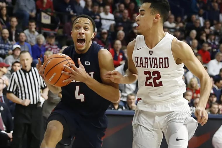 Penn’s Darnell Foreman drives past Harvard’s Christian Juzang during the championship of this year’s Ivy League tournament at the Palestra.