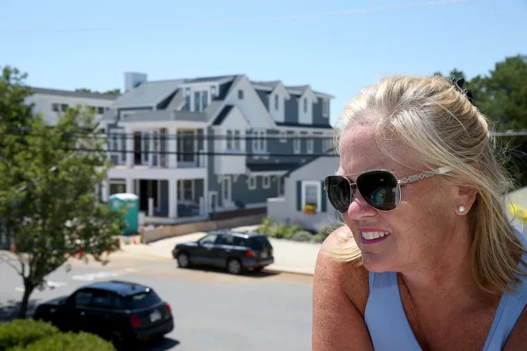 Julie Donatelli stands on her balcony with a construction site across the street in Avalon, NJ on July 19, 2018.