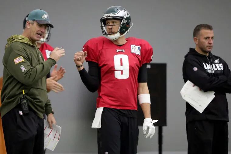 Eagles offensive coordinator Frank Reich, left, and Nick Foles talk as the Philadelphia Eagles practice for the NFC Championship game against the Minnesota Vikings in Philadelphia, PA on January 17, 2018. DAVID MAIALETTI / Staff Photographer