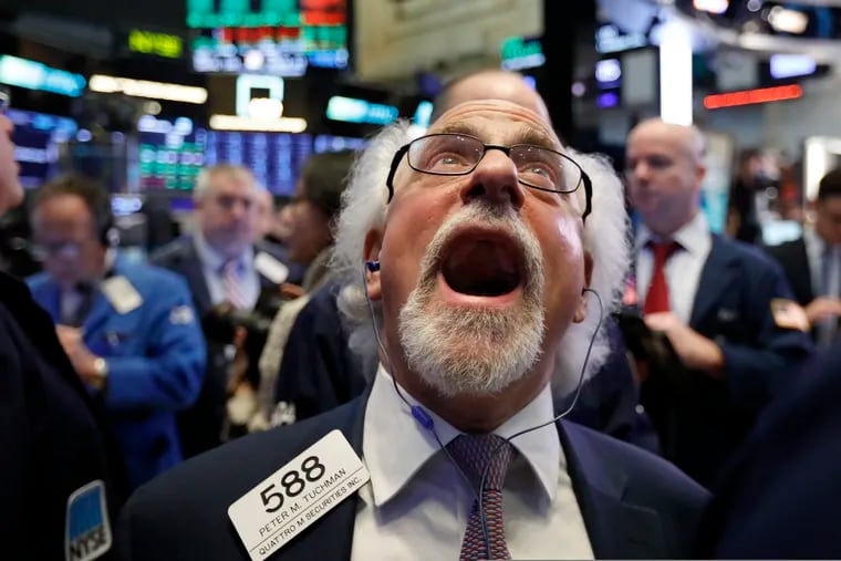Trader Peter Tuchman on the floor of the New York Stock Exchange last week. Stocks capped off a losing year on Monday.