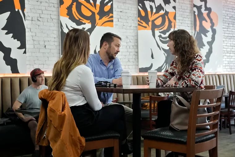 Customers drink coffee at the Blind Tiger Cafe in January in Tampa, Fla.
