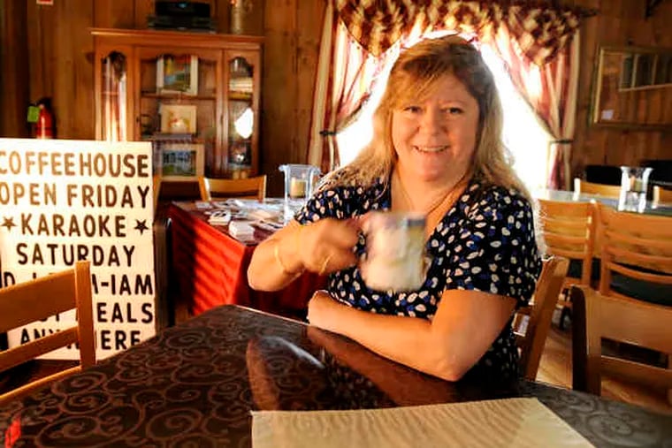 Founder Barri Pepe has a cup of tea in the coffeehouse area of Myra's Place on MacDade Boulevard in Collingdale.