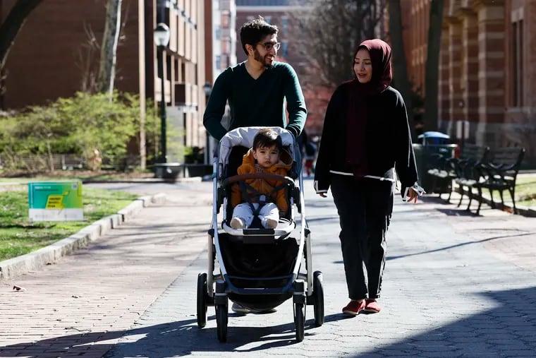 Raza and Kaamela Shirazie and their 18-month-old son Akbar take a walk on the University of Pennsylvania campus on Monday, March 11, 2024.
