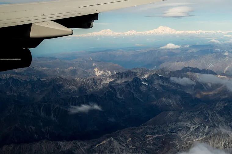 ASSOCIATED PRESS The newly renamed Denali is seen from a window of Air Force One carrying President Obama to Anchorage, Alaska.