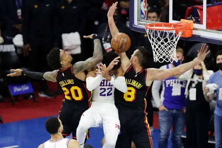 Sixers guard Matisse Thybulle getting fouled after receiving the basketball from teammate Ben Simmons against Atlanta Hawks forward John Collins and forward Danilo Gallinari in the fourth quarter in Game 7 of the NBA Eastern Conference playoff semifinals on June 20, 2021 in Philadelphia.