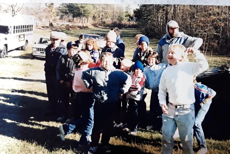 Wilderness Scouts of Blairsville, Georgia wait with their leader, Harold Cornwell, to board a bus sent by Donald Trump for their Christmas activities in 1988.