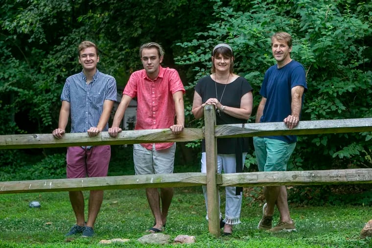 Chase (left) and brother Noah (second from left) along with parents Emily and David Mendell at their home in Wallingford. The parents were empty nesters until the sons returned home from college due to COVID-19.