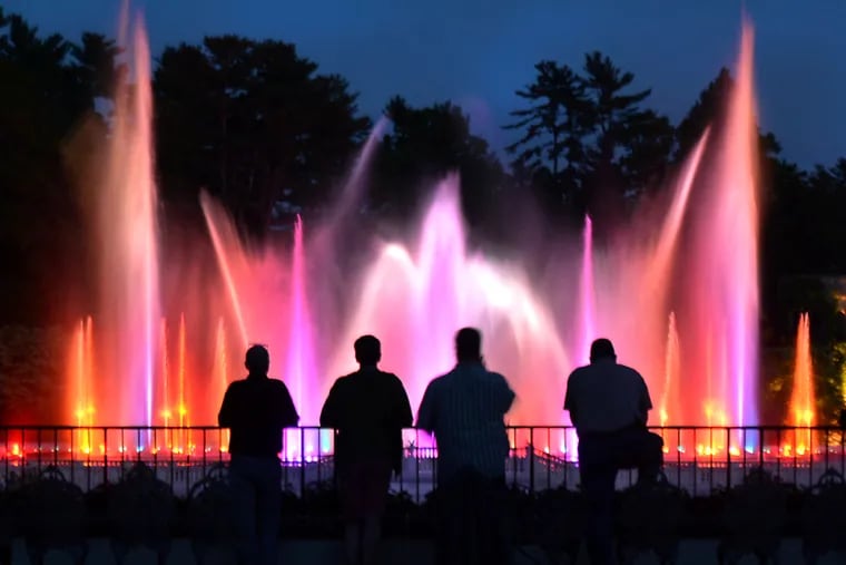 Staff members inspect the spectacular illuminated fountains choreographed to music at Longwood Gardens in Kennett Square on Tuesday evening May 16,2017.