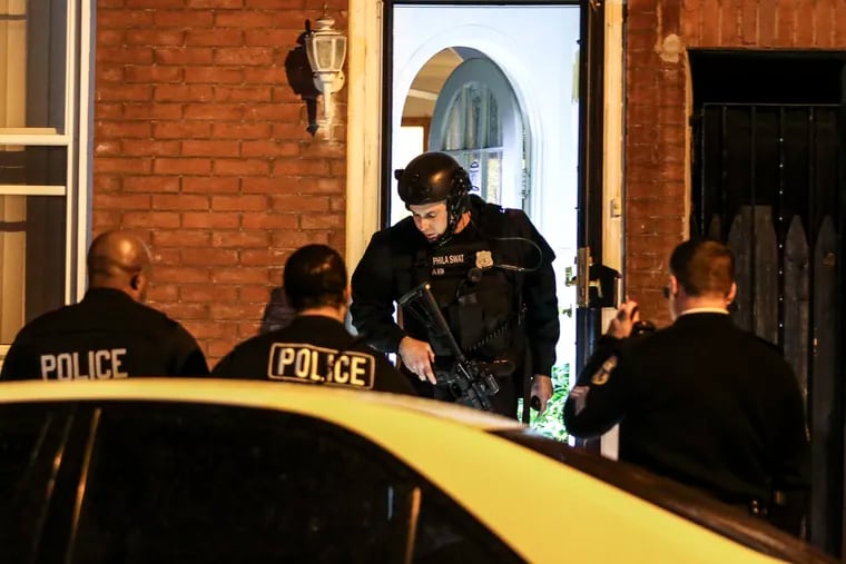 Police and SWAT officers on the scene in the 1400 block of North Lawrence Street. A police officer was shot shortly after 10 p.m. in the area and was reported in stable condition at Temple University Hospital. Tuesday, Dec. 21, 2021.