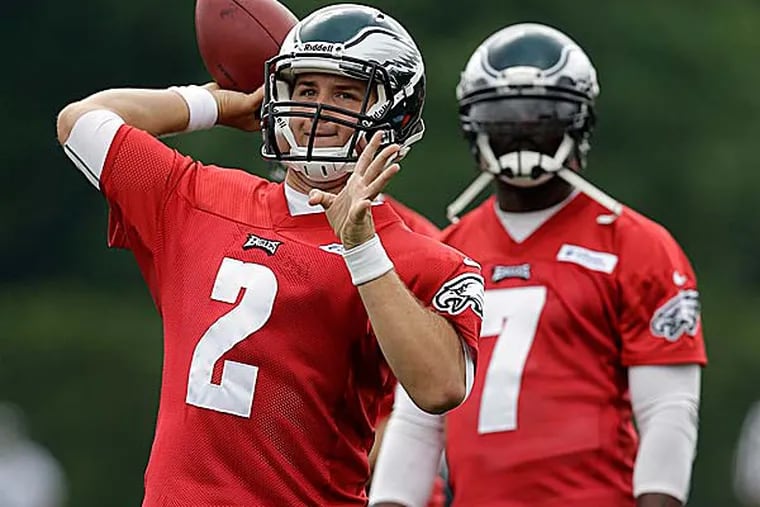 The Eagles have a good, old fashioned quarterback competition that will play out through the hot days of training camp. (Matt Rourke/AP)