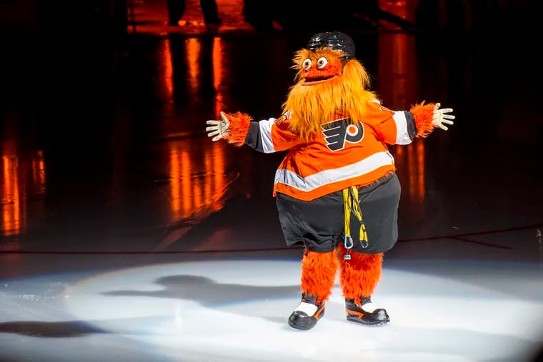 Gritty lands on the ice after making his appearance by rappelling down from the rafters before the Flyers' home opener last season.