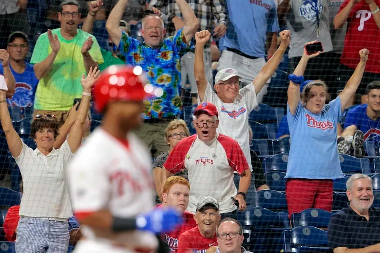 Philies fans cheer as Jean Segura waits for Phils Andrew Knapp who just scored the game winning run on a walk off passed ball in the bottom of the 9th inning of the Chicago Cubs at Philadelphia Phillies MLB game at Citizens Bank Park in Phila., Pa. on Sept. 15, 2021. The Phillies win the game 6-5.