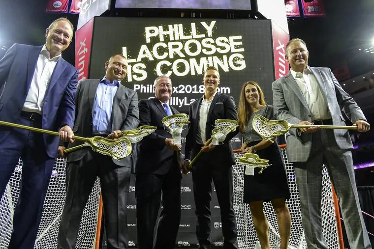 Holding golden lacrosse sticks after a press conference at the Wells Fargo Center September 14, 2017 where it was announced that Comcast Spectacor was acquiring an expansion National Lacrosse League team. The dignitaries are (from left): Dave Scott, president and ceo of Comcast Spectacor; Shawn Tilger, coo of the Flyers who will be the new team's Governor; Mayor Kenney, who actually played box lacrosse in his younger years; Sean Delaney, the new team's ex. dir. of lacrosse operations; Lindsey Masciangelo, ex.dir. of business operations for the team; and NLL commissioner Nick Sakiewicz. Play for the as-yet-unnamed team will begin with teh 2018-19 season.