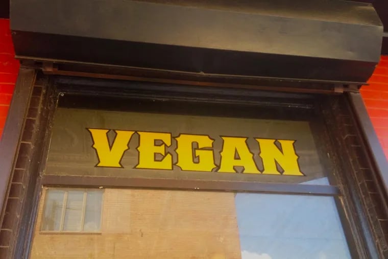A window at Grindcore House Cafe touts its animal-free menu.