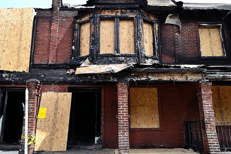 Homes destroyed by Saturday's fire on the 6500 block of Gesner St. in Southwest Philadelphia were opened up and inspected by city officials on Monday, July 7, 2014.  (C.F. Sanchez / Staff Photographer)