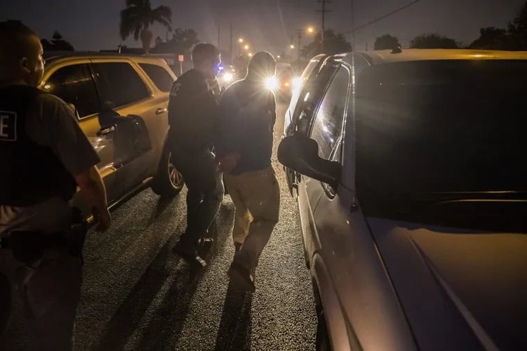 Immigration and Customs Enforcement agents take Mexican national Santiago Mondragon into custody on a Downey street while he was on his way to work on April 18, 2017 in Downey, Calif. (Brian van der Brug/Los Angeles Times/TNS)
