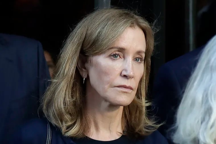 This Sept. 13, 2019 file photo shows actress Felicity Huffman leaving federal court after her sentencing in a nationwide college admissions bribery scandal in Boston. A representative for Huffman says she reported to a federal prison in California to serve a two-week sentence on Tuesday, Oct. 15.
