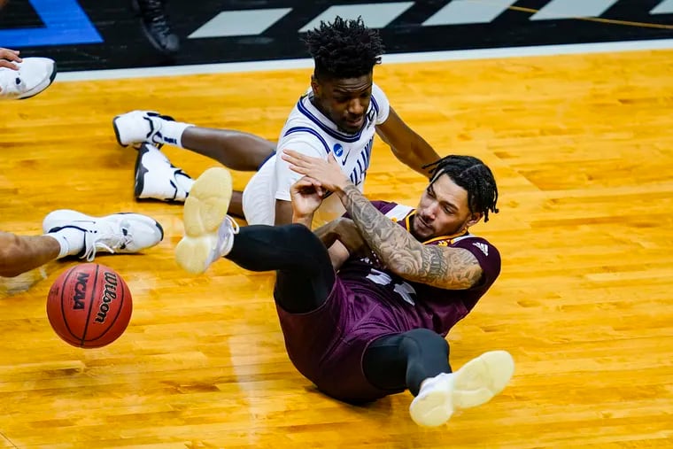 Villanova guard Bryan Antoine (1) and Winthrop guard Josh Corbin (32) go to the floor Friday for a loose ball in the second half of a first round game in the NCAA men’s college basketball tournament in Indianapolis, Antoine has been one of the sparks of the Wildcats' improving defense.