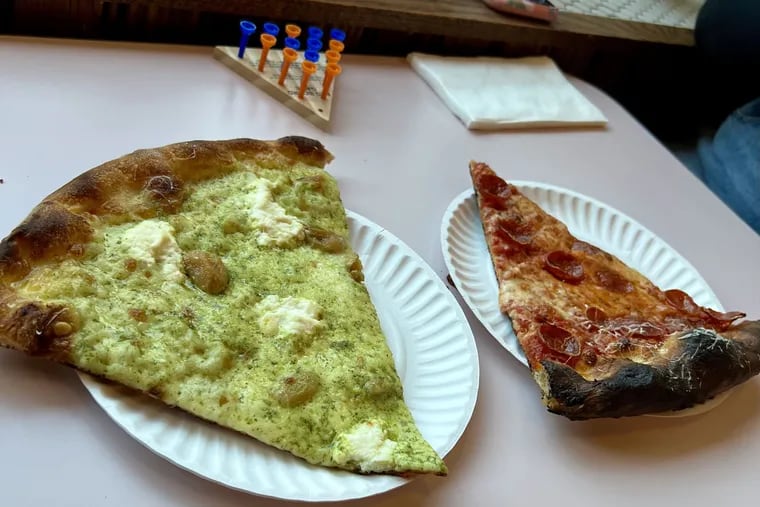 Basil cream, confit garlic, ricotta, Fontina, and mozzarella atop a white pizza at Pizza Richmond, beside a slice of pepperoni.