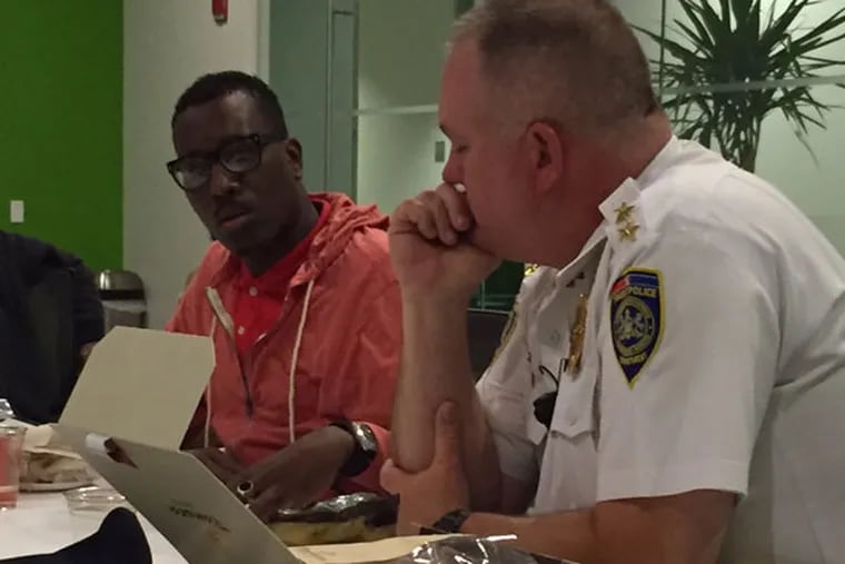 Asa Khalif (left), of the Pennsylvania chapter of Black Lives Matter, discusses “Peace Officer” with SEPTA Police Chief Thomas Nestel.