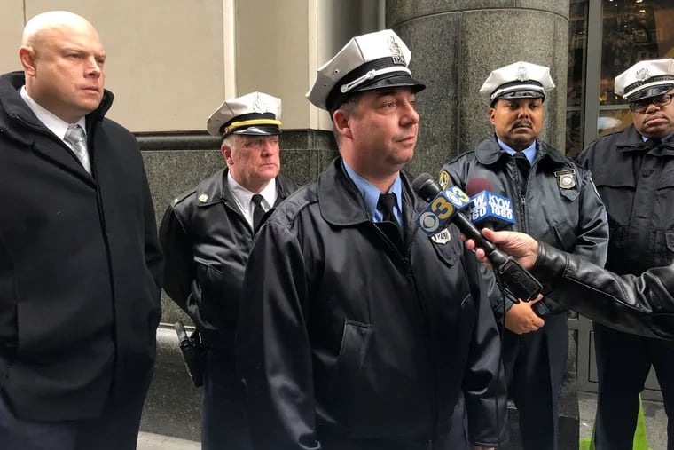 Philadelphia Police Officer Ed Davies, who was shot on duty in 2013, speaks to reporters outside the Criminal Justice Center on Thursday, Dec. 20, 2018. He said he plans to attend his alleged shooter's second trial.